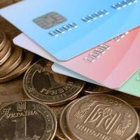 Ukrainian money coins and colored credit cards close up photo