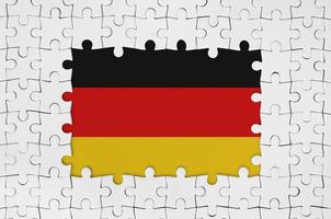 Germany flag in frame of white puzzle pieces with missing central part photo