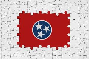 Tennessee US state flag in frame of white puzzle pieces with missing central part photo
