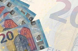 20 euro bills lies in stack on background of big semi-transparent banknote. Abstract business background photo