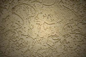 The texture of the beige decorative plaster in bark beetle style photo