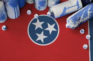 Tennessee US state flag and few used aerosol spray cans for graffiti painting. Street art culture concept photo