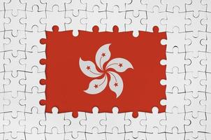 Hong kong flag in frame of white puzzle pieces with missing central part photo