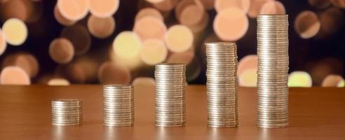 Golden coin stacks arranged as a graph. Increasing columns of coins photo