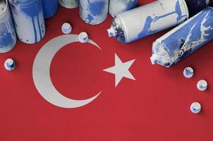 Turkey flag and few used aerosol spray cans for graffiti painting. Street art culture concept photo