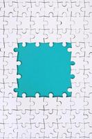 Framing in the form of a rectangle, made of a white jigsaw puzzle around the blue space photo