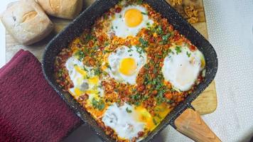 Fried eggs in Georgian cuisine, chirbuli. Eggs with tomatoes steaming in the pan video