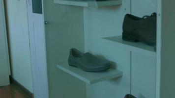 The shoe factory. There are pieces of shoes in the background. The sole and the mannequin video