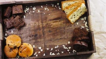 Different kinds of cakes arranged on a wooden tray video