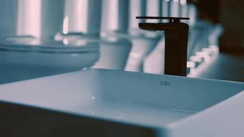 Rotating washbasin. Studio filming. In the background a row of toilets. 4k video