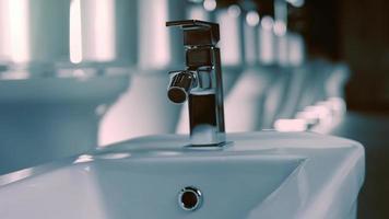 Rotating washbasin. Studio filming. In the background a row of toilets. 4k video