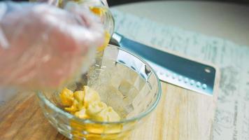 The chef mixes the ingredients for the honey and mustard sauce with a golden spoon video