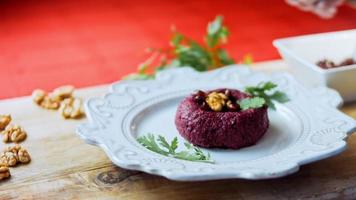 Pkhali traditional Georgian food. Beetroot is used for the purple color. Walnut is used for decoration video