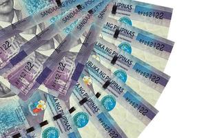 100 Philippine piso bills lies isolated on white background with copy space stacked in fan shape close up photo