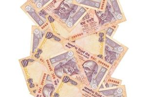 10 Indian rupees bills flying down isolated on white. Many banknotes falling with white copyspace on left and right side photo