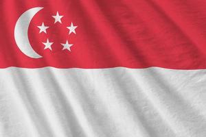Singapore flag with big folds waving close up under the studio light indoors. The official symbols and colors in banner photo