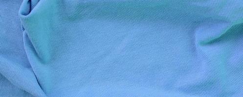 The texture of the fabric in blue color. Material for making shirts and blouses photo