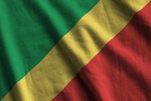 Congo flag with big folds waving close up under the studio light indoors. The official symbols and colors in banner photo