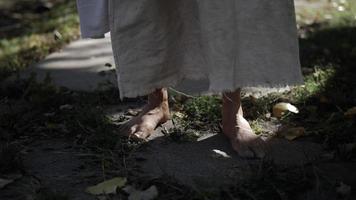 The Feet Of Jesus Christ Wearing White Robe Walking In Dramatic Slow Motion video