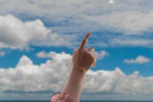 Praying hands on blue sky background,Young man prayed,Religion and spirituality with believe photo