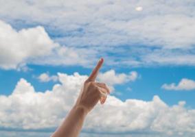 Praying hands on blue sky background,Young man prayed,Religion and spirituality with believe photo