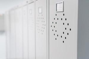 Gray metal lockers in the dressing room for clothes in a row. photo