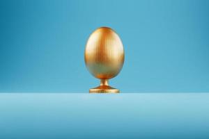 Golden egg on a blue background with a minimalistic concept. Space for text. Easter egg design templates. Stylish decor with minimal concept. photo