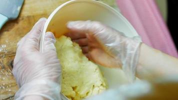 Mix the cake ingredients with the mixer. The baby is sitting in a chair and enjoying himself video