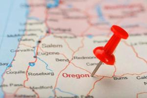 Red clerical needle on a map of USA, Oregon and the capital Salem. Closeup Map Oregon with Red Tack photo