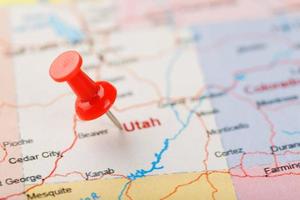 Red clerical needle on a map of USA, Utah and the capital Salt Lake City. Closeup Map Utah with Red Tack photo