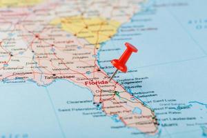 Red clerical needle on a map of USA, South Florida and the capital Tallahassee. Close up map of South Florida with red tack photo