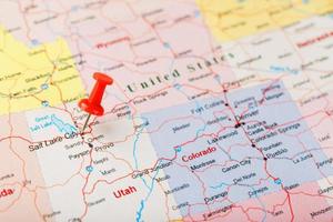 Red clerical needle on a map of USA, Utah and the capital Salt Lake City. Closeup Map Utah with Red Tack photo