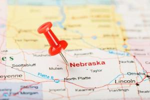 Red clerical needle on a map of USA, Nebraska and the capital Lincoln. Close up map of Nebraska with red tack photo
