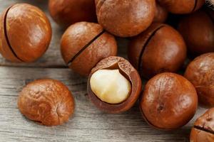 Macadamia nut on a wooden table in a bag, closeup, top view photo