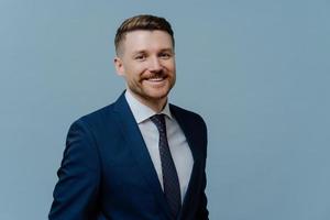 Portrait of successful businessman in suit smiling at camera photo