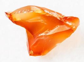 raw crystal of cornelian red chalcedony on white photo