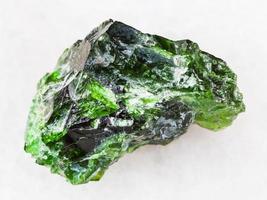 green crystal of Chrome Diopside gemstone on white photo