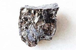 rough bituminous coal black coal on white marble photo