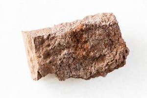 rough Bauxite rock on white marble photo