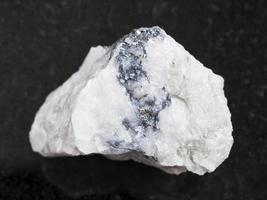 rough Wolframite ore on dark background photo