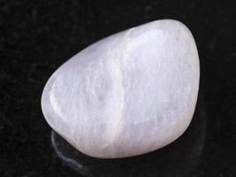 tumbled pink petalite gemstone on dark photo