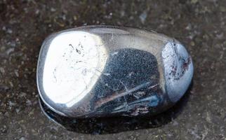 polished Hematite rock on black photo