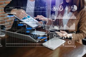 Businessman hand Project manager working and update tasks and Gantt chart scheduling virtual diagram.with smart phone, tablet and laptop in office. photo