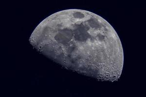 Surface of the Moon on black background, close up. photo