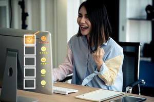 Young Asian happy woman using computer with customer service and five stars satisfaction rating. photo
