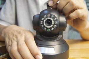 Conceptual man operating ip camera photo