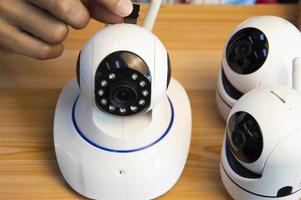 Conceptual man operating ip camera photo