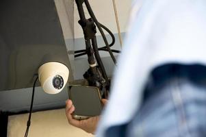 Conceptual man operating ip camera photo