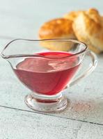 Glass boat of red currant jam photo