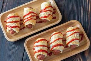 Sausage rolls on the wooden tray photo